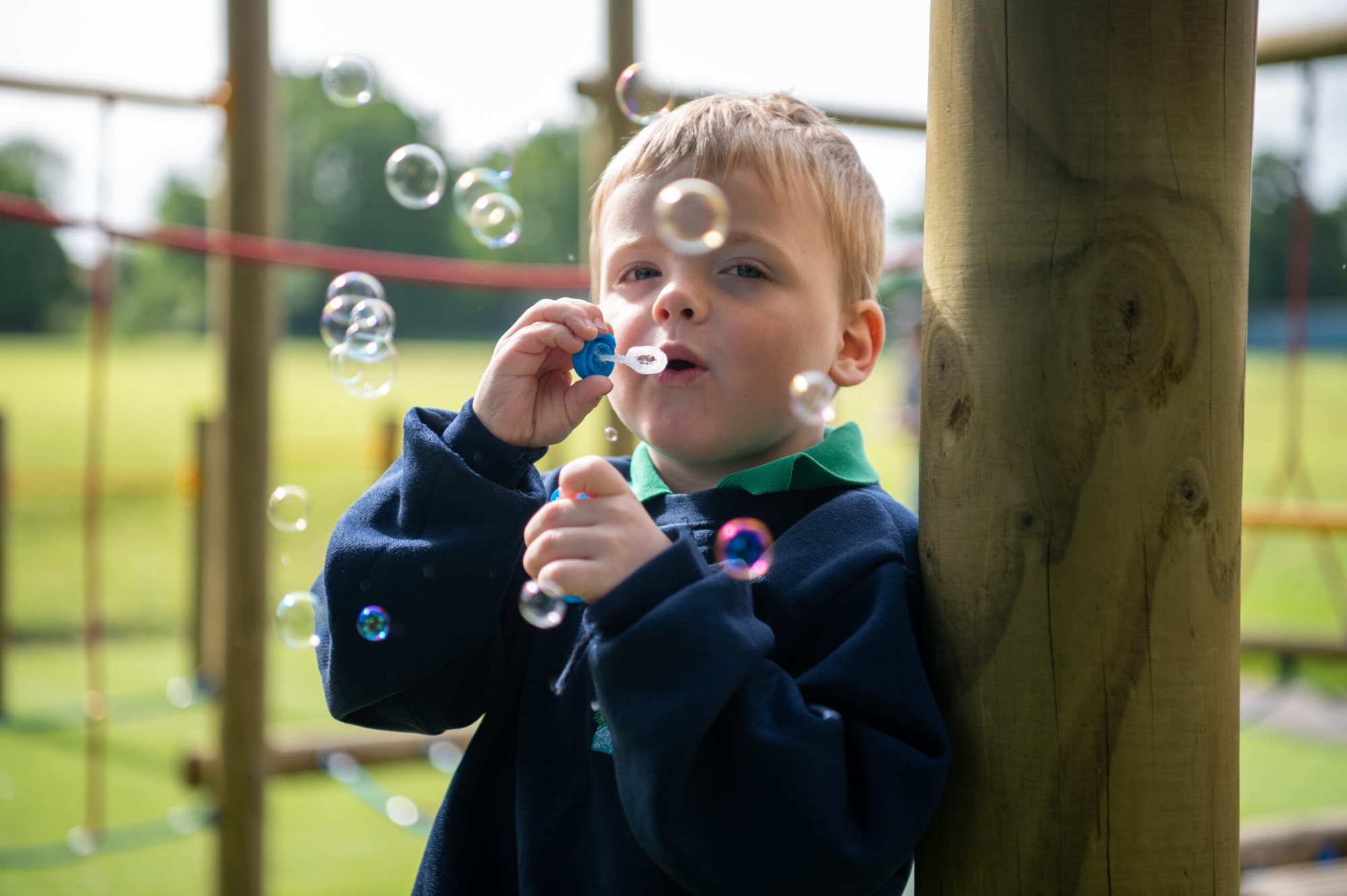 Child outside blowing bubbles