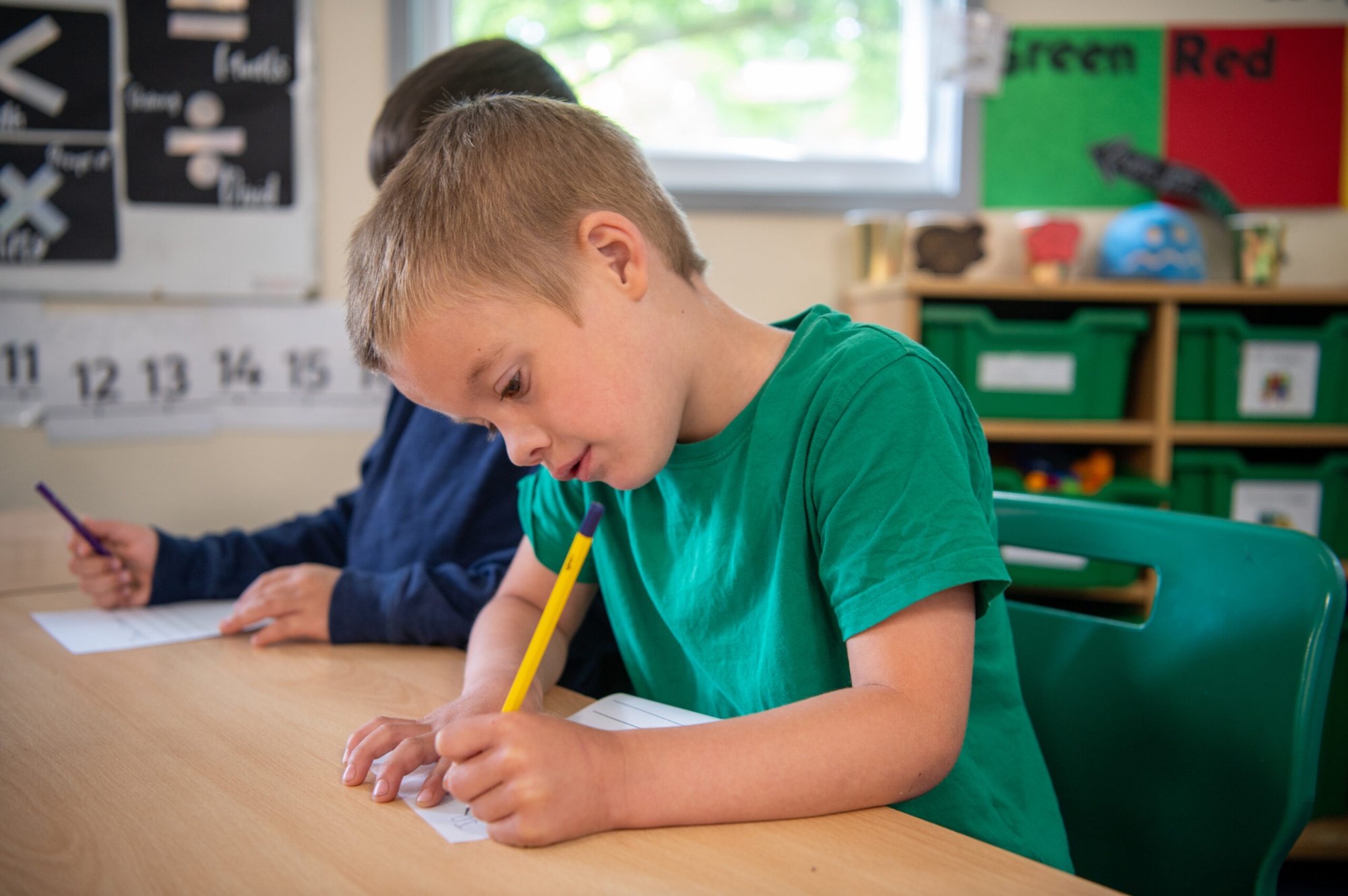 Pupils writing in the classroom