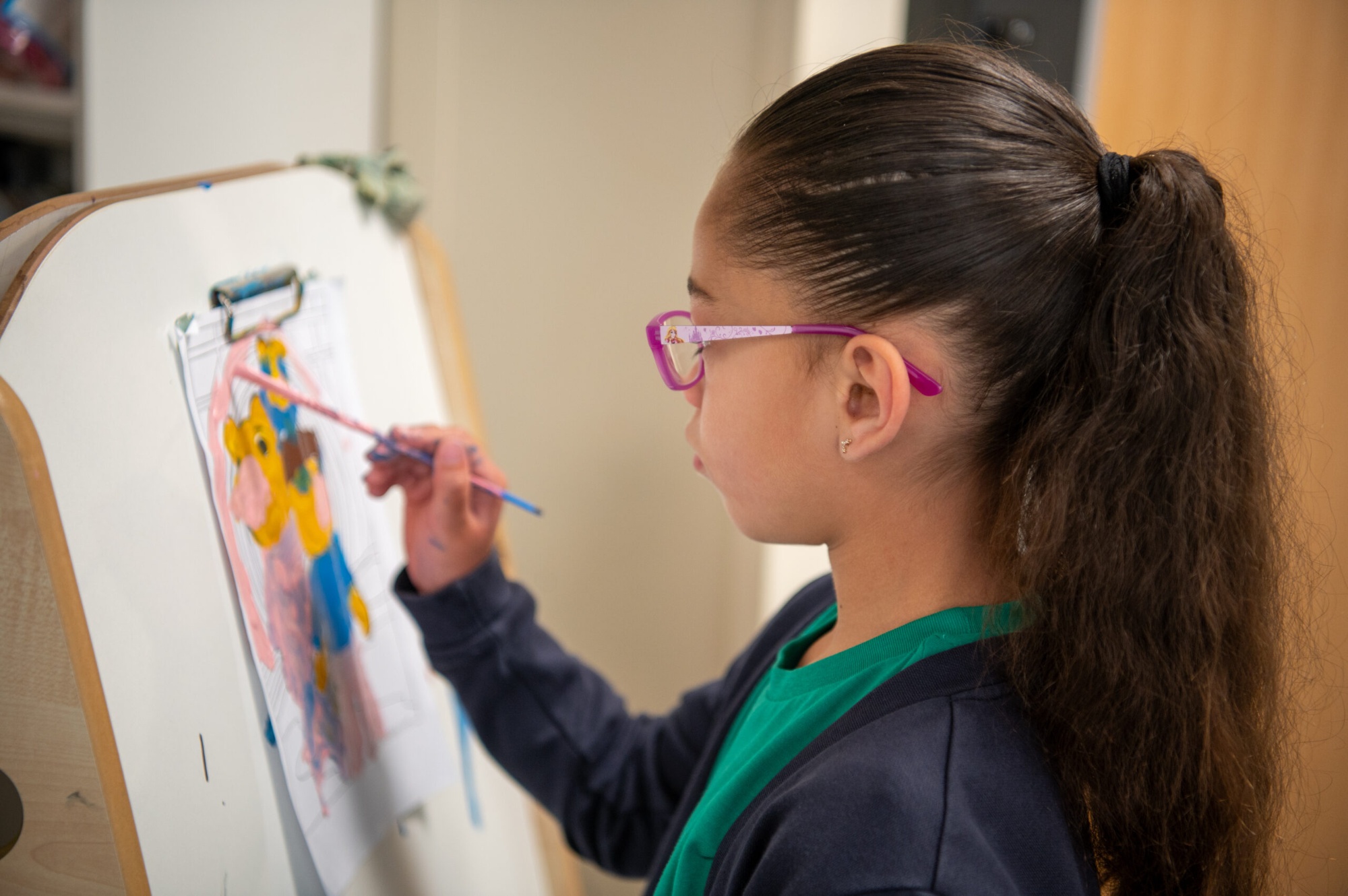 Child painting inside the classroom